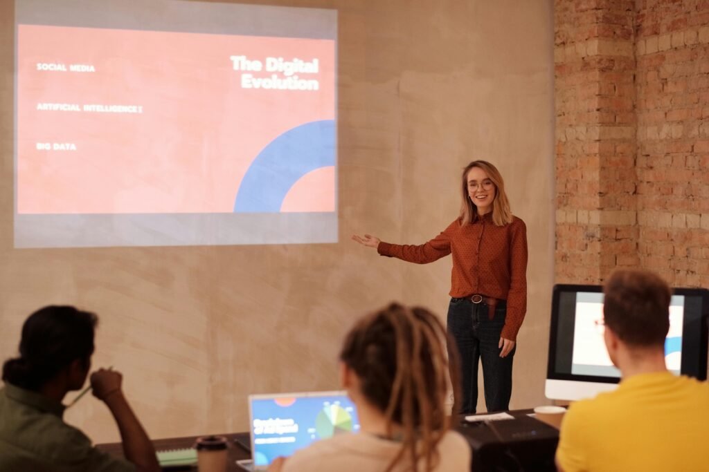 Young woman presenting digital evolution concepts to a classroom audience.