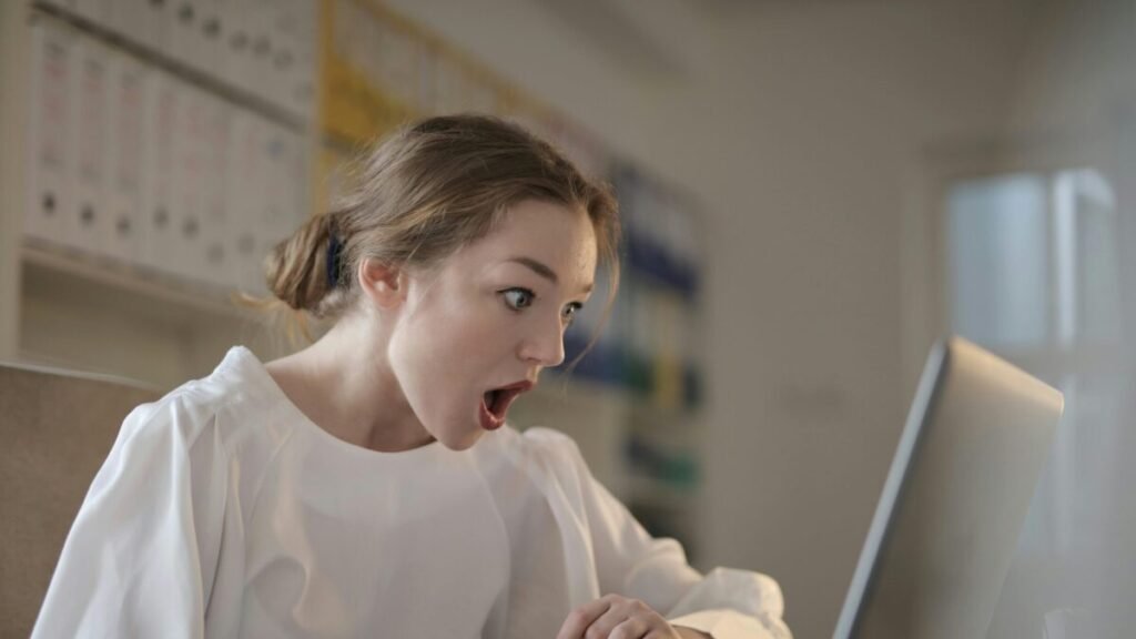 Woman shocked while using laptop.