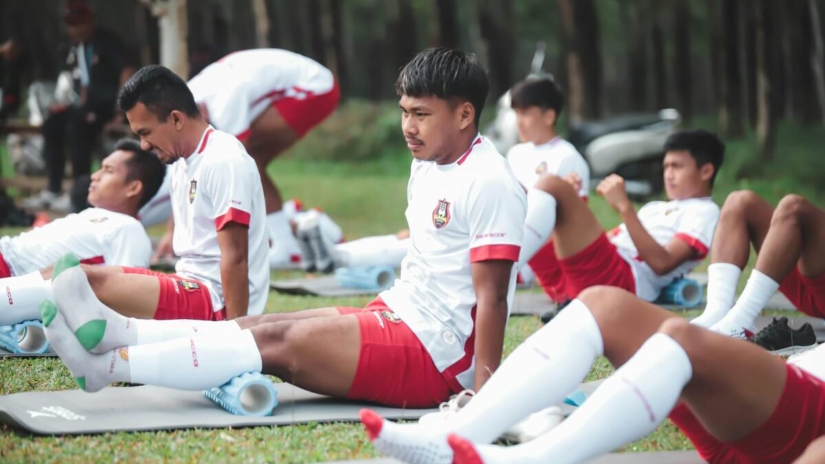 Football players training on the field with modern techniques and teamwork