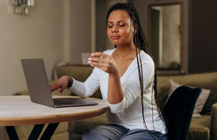 Woman shopping online using a laptop.